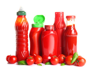 Bottles of ketchup and tomatoes on white background