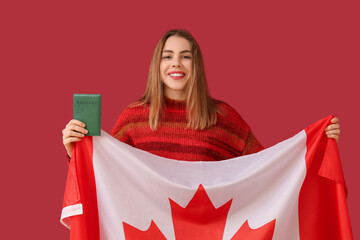 Poster - Beautiful young happy woman with Canadian flag and passport on red background