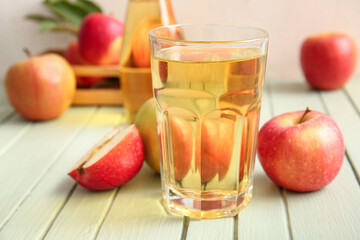 Wall Mural - Composition with fruits and glass of fresh tasty apple cider on green wooden table, closeup