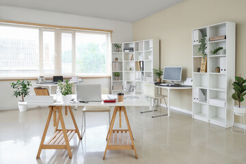 Canvas Print - Interior of stylish office with workplaces, laptop and shelving unit