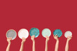 © Pixel-Shot - Hands holding empty plates on red background