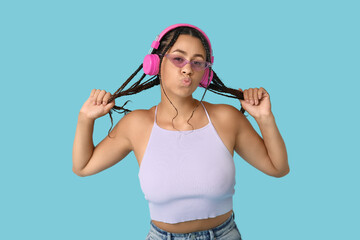 Poster - Emotional African-American woman listening to music on blue background