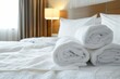 © Maxim Borbut - In beauty bedroom, bed maid, clean white pillows, sheets and bed linen. Close-up. Interior background. Towel in Hotel Room, Welcome Guests, Room Service.