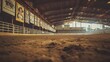 © Prostock-studio - The floor of a dirt arena is visible, surrounded by colorful banners hanging on the walls under bright lights.