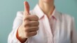 © Intelligent Horizons - Close up photograph of a hand making a thumbs up gesture conveying a sense of customer satisfaction positive feedback and approval  The image represents the concept of successful client service