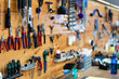 © JackF - Variety of hand tools for bicycle repair neatly arranged on wooden wall in specialized professional bike workshop