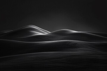 A serene black and white landscape of gentle rolling hills, evoking tranquility and depth.