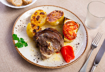 Wall Mural - Appetizing baked pork cheek served with potatoes and vegetables on plate