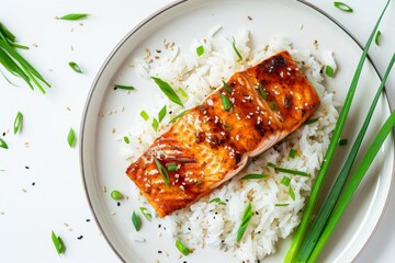 Bird's-eye view of perfectly cooked teriyaki salmon filet on a bed of rice, with green onions, minimal background.Teriyaki soy sauce.Teriyaki.Teriyaki chicken.Asian cuisine.