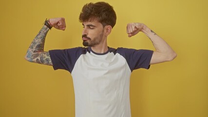 Poster - Smiling, confident young hispanic man showing fit muscles, standing alone against an isolated yellow background, a representation of fitness concept