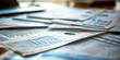 © Jirawatfoto - Business Documents and Graphs Scattered on Table in Office Workspace. Corporate Data Analysis and Financial Reports Organization