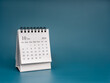 © tete_escape - White October 2024 page, desk calendar for plan and reminder isolated on dark blue background with copy space. Simple small minimal calendar 10th month, for business agenda and schedule concept.