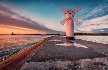 Wall Mural - Astonishing summer view of Stawa windmill. Breathtaking sunrise on Szczecin Lagoon. Nice morning seascape of Baltic Sea, Swinoujscie, Western Pomerania, Poland, Europe. Traveling concept background..