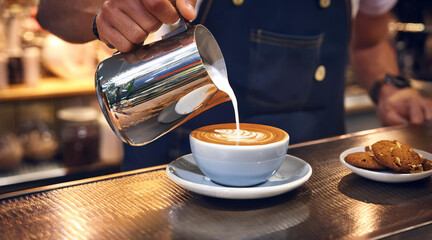 Barista Pouring Artisan Coffee with Latte Art