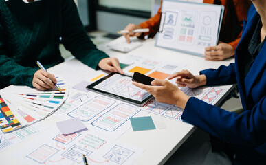 Wall Mural - ux developer and ui designer brainstorming about mobile app interface wireframe design with customer