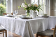 © Joesunt - Serene Dining: Pristine white tablecloth adorns a table set for a meal, sunlight streaming in, exuding elegance and simplicity.