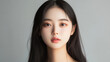 © Chatchanan - Front view of a 20-year-old Korean woman with a perfectly balanced face and natural beauty, featuring clear, unblemished skin and long hair, suitable for a realistic passport photo.