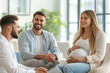 © lenblr - Happy pregnant woman and her husband smiling while listening to the doctor explaining something on the ultrasound scan