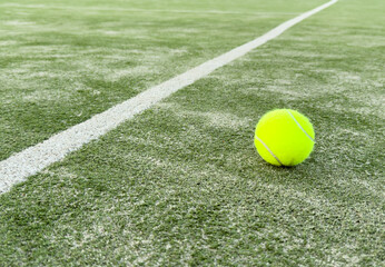 Tennis ball on grass tennis court