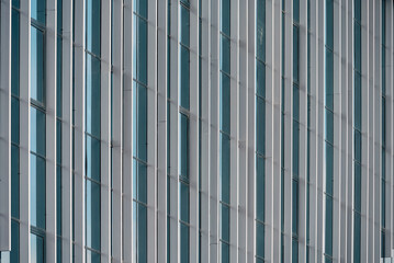 Wall Mural - empty glass windows of a modern building with a reflection of the sky in the glass