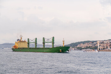 Poster - A cargo ship navigates the Bosphorus near Istanbul's coastline, showcasing
