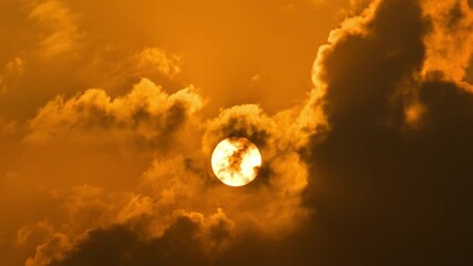 Wall Mural - time lapse of dramatic sunrise with orange sky in a cloudy day.