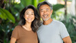 © Studios - Portrait happy Asian middle age couple smiling at the camera