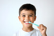 © Oksana_Latysheva - Little boy brushing  teeth with a toothbrush isolated on white background