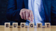 © rawintanpin - Budget Financial planning and management concept, Company budget allocation for business project management, Effective and smart budgeting, Word budget word on wooden cubes.