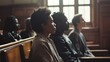 © VK Studio - Courtroom attendees intently follow a case's arguments, the light illuminating expressions of focus and determination in the classic setting.