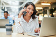 © TasJam/peopleimages.com - Office, laptop and businesswoman in phone call with contact, networking and schedule for interview. Smile, female journalist and mobile with computer for research, scroll or questions for news source