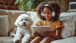 © Vika art - Little girl in headphones holding tablet and her dog sitting near.