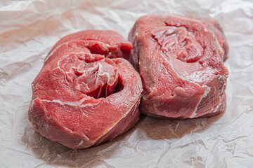 fresh raw beef on white parchment close up