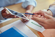 © peopleimages.com - Hands, tablet and documents at startup for teamwork at meeting, pointing and planning for financial strategy. People, paperwork and digital touchscreen with app, partnership and solution at agency