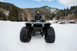 © Studio Peace - Man is sitting on a huge all-terrain vehicle, a swamp walker, in a snow-covered forest.