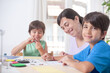 © OR MIXphoto - Mother and children making handicrafts. On their faces there is a smile reflecting happiness.