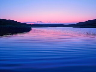 Wall Mural - Calm river at dusk with reflections and gentle waves near rolling hills