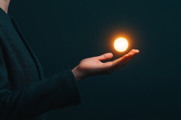 A person is holding a glowing ball in their hand