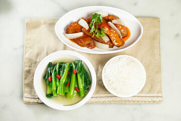 Kyoto steak or Pork Chop in Peking Style with baby kailan and white rice served in dish isolated on napkin top view of asian food