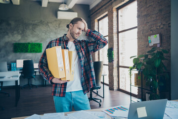 Wall Mural - Photo of young corporate man hand touch head hold folders wear shirt loft interior modern office indoors