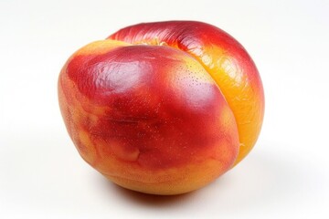 Wall Mural - A ripe, juicy nectarine with a smooth red and yellow skin, isolated on a pure white background