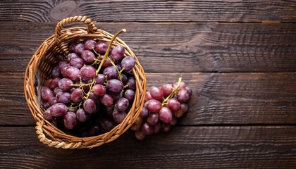 Wall Mural - Upper view of a bunch of fresh sweet grapes in a wicker basket on the dark woode, generative IA