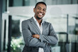 © peopleimages.com - Smile, crossed arms and portrait of black man in office with confidence for financial career. Happy, finance and African underwriter with pride for company investment risk evaluation in workplace.