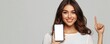 © ALEXSTUDIO - Smiling woman showing smartphone with blank screen pointing up