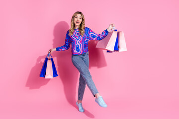 Poster - Photo of girl enjoy shopping days buying clothes holding different packages gifts black friday promoter isolated on pink color background