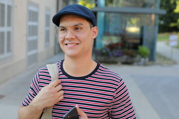 Cute male student with his backpack 