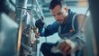 © somneuk - Technician working on a commercial HVAC system, fixing mechanical components and restoring functionality. The technician is wearing a uniform and using tools to complete the emergency repair service.
