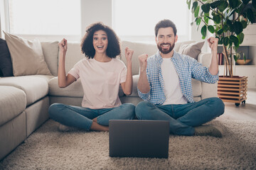 Sticker - Full length portrait of two nice young people raise fists laptop weekend modern apartment indoors