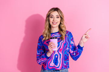 Wall Mural - Photo of gorgeous blonde curly hair lady wearing bright stylish sweatshirt direct finger coffee shop isolated on pink color background