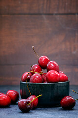 ripe cherries on a dark wooden background